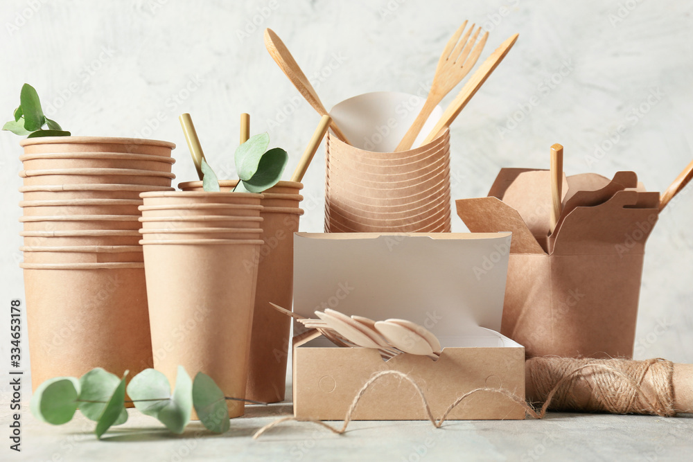 Eco containers for food and drinks on light background