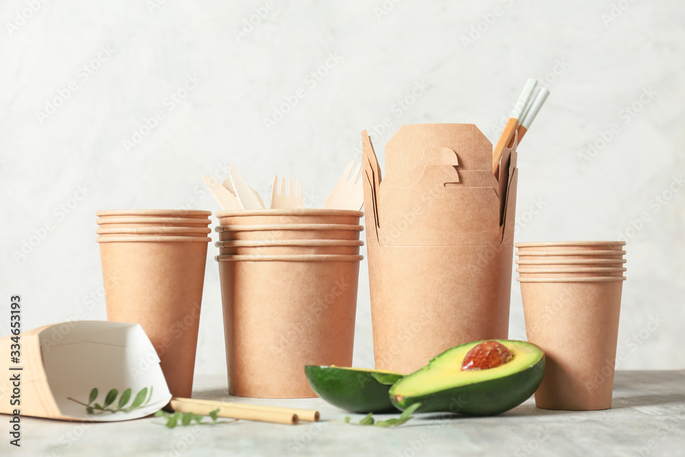 Eco containers for food and drinks on light background