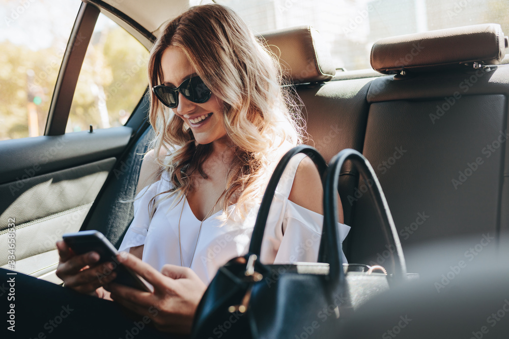 Smiling woman traveling by a car