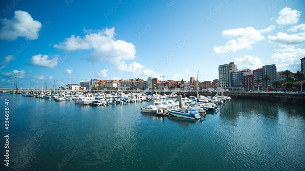 Yachts and boats docking at port at sunset