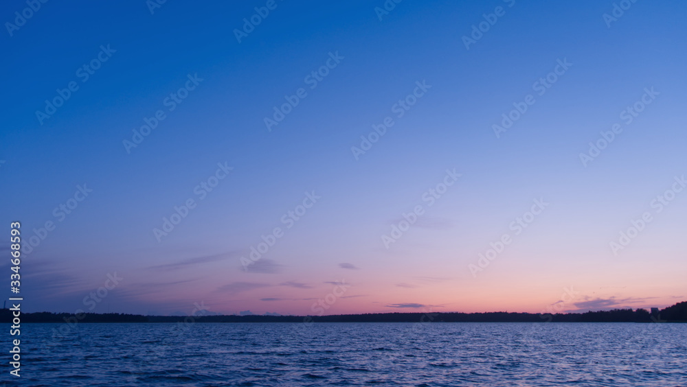 Lake at sunset; beautiful blue sky