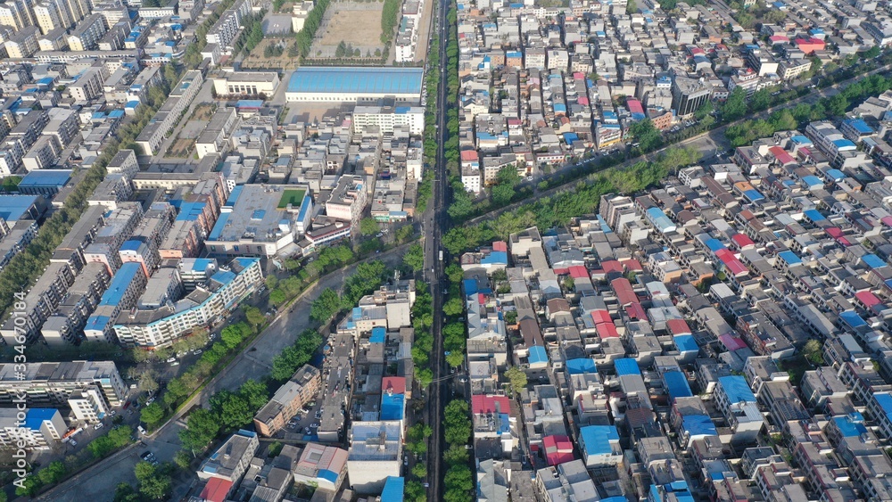 Aerial view of city buildings and roads in early morning sunlight, China