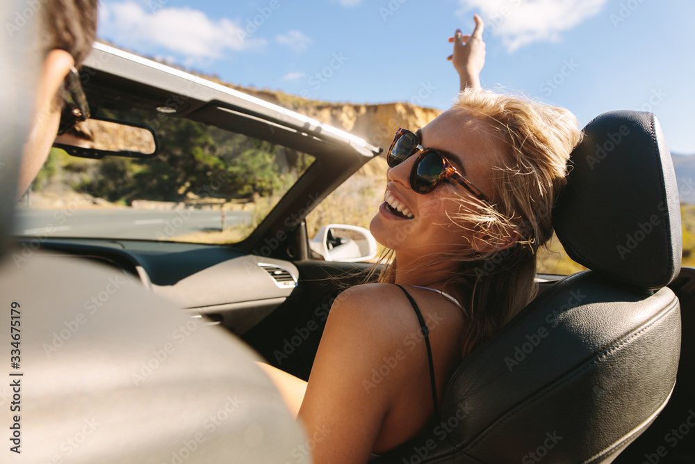 Woman enjoying on a roadtrip with her boyfriend