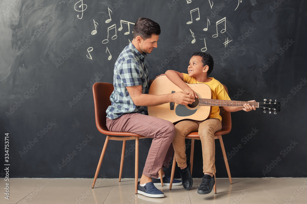 Teacher giving music lessons at school