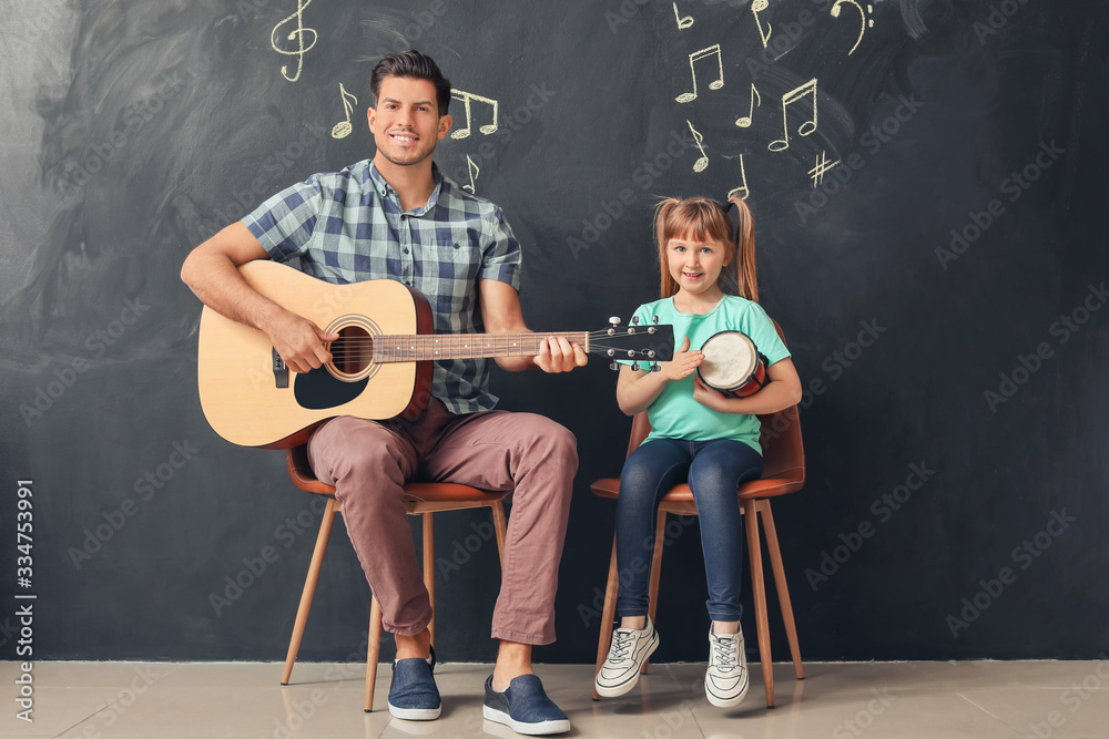 Teacher giving music lessons at school