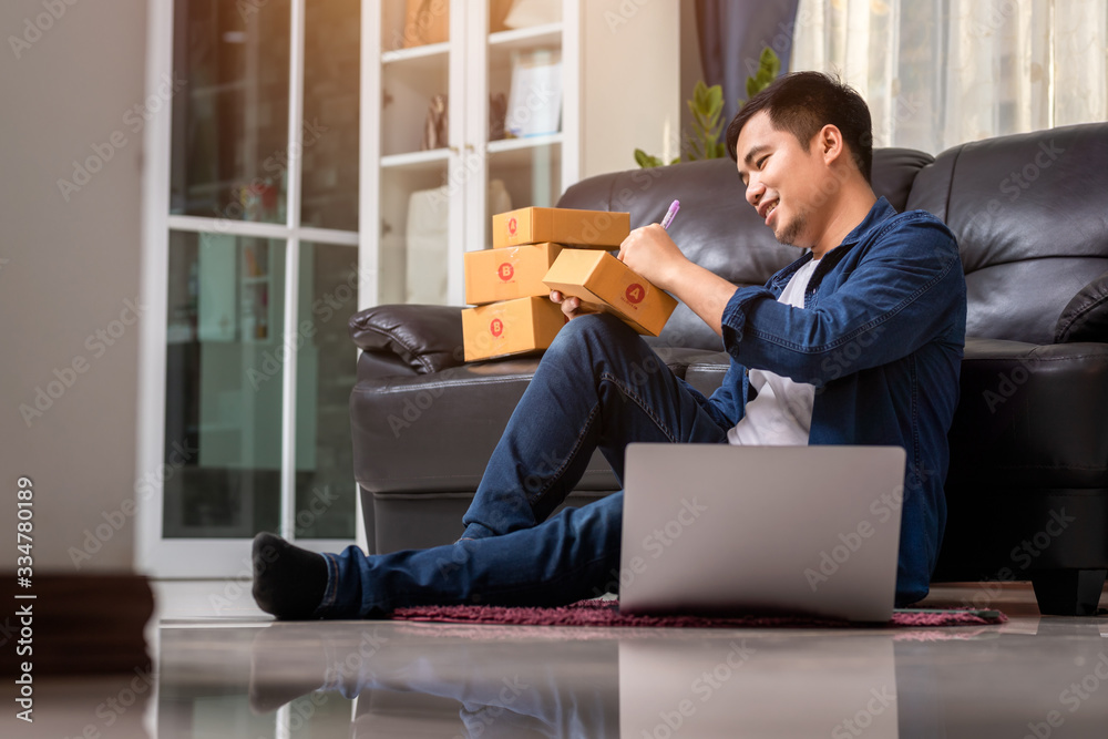 Online sales young start small business in a cardboard box at work. The seller prepares the delivery