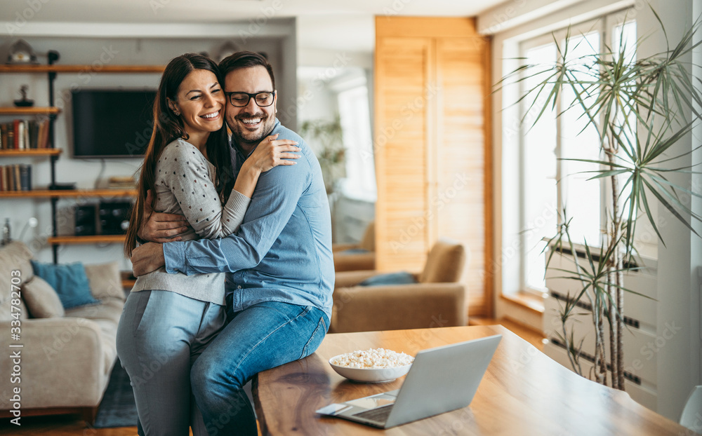 Affectionate couple relaxing at home, portrait. 