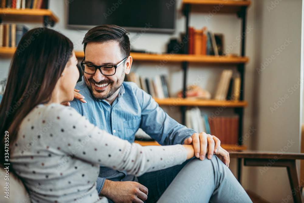 Happy couple relaxing at home, copy space, portrait.