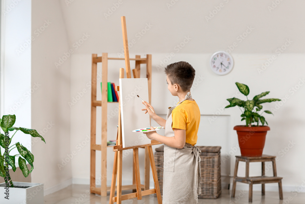 Cute little artist painting at home