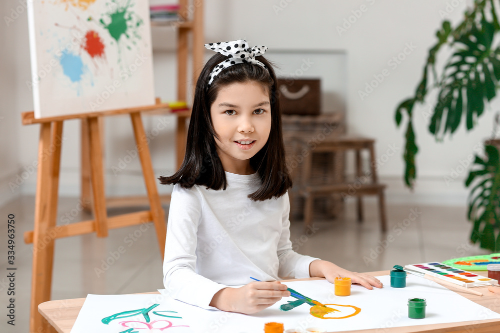 Cute little girl painting at home