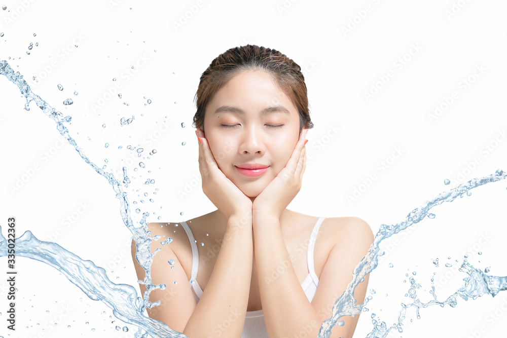 Asian Beautiful model. Beautiful Smiling girl under splash of water with fresh skin on white backgro