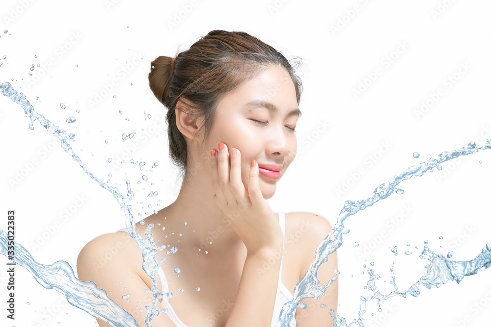 Asian Beautiful model. Beautiful Smiling girl under splash of water with fresh skin on white backgro