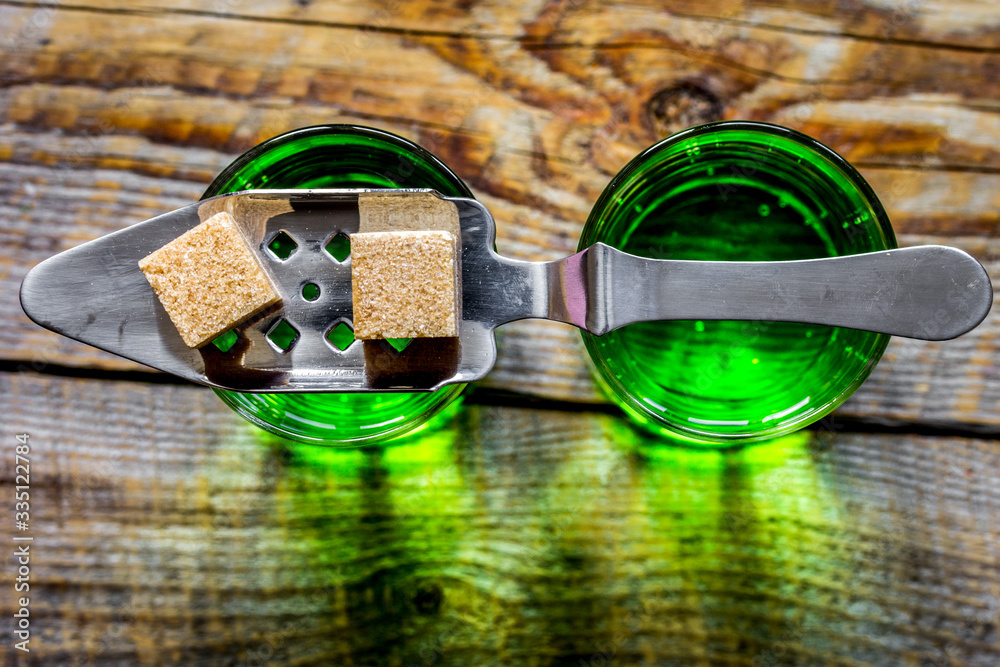 green shots with sugar on table background top view