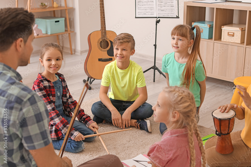 Teacher giving music lessons at school