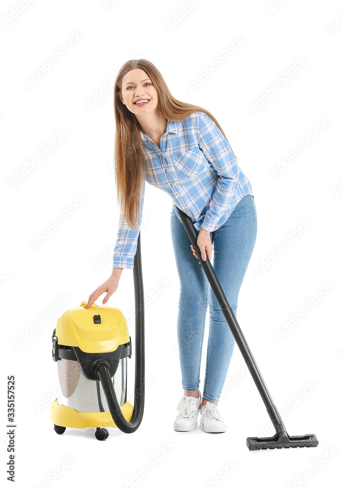 Young woman with vacuum cleaner on white background