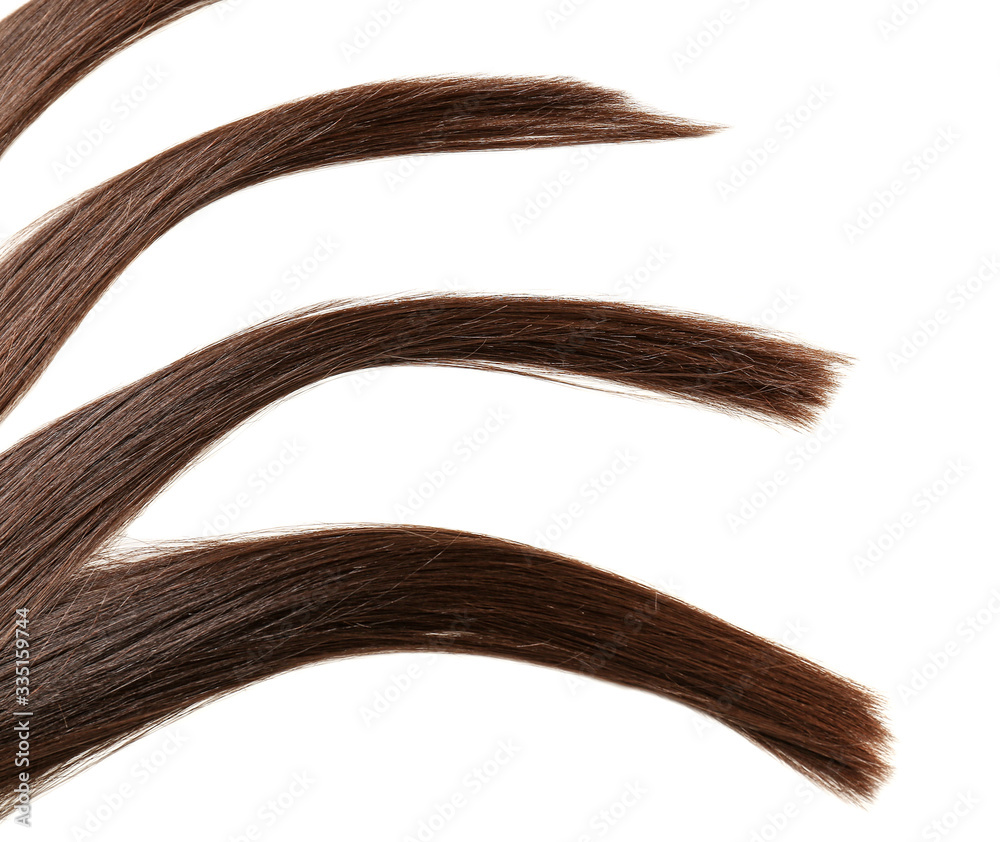 Strands of beautiful straight hair on white background