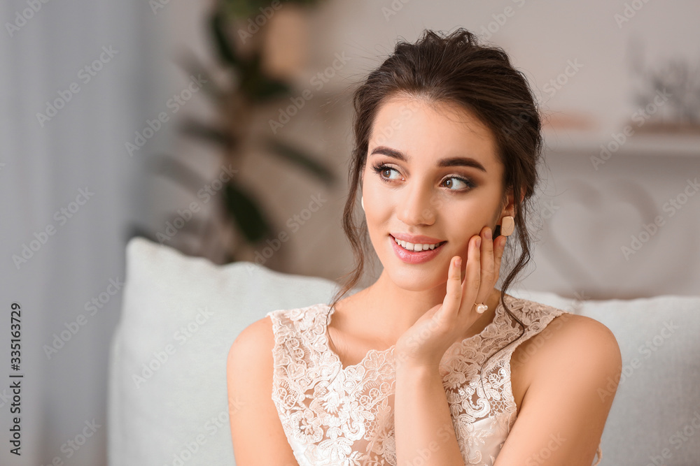 Young bride with beautiful hairdo at home