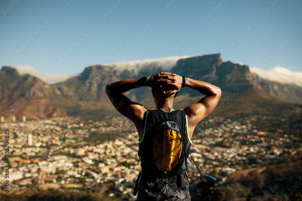 Athletic man taking a break after trail running