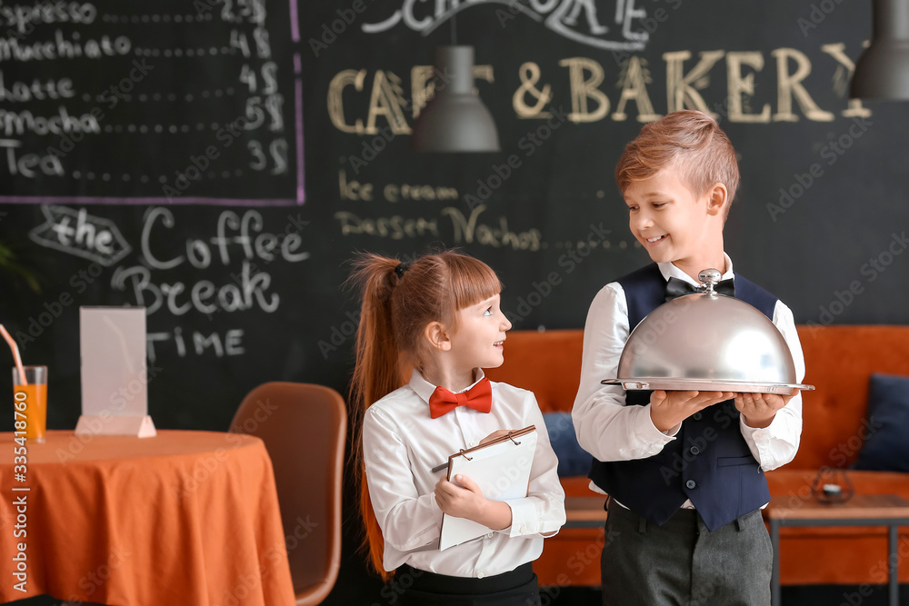 Cute little waiters in restaurant