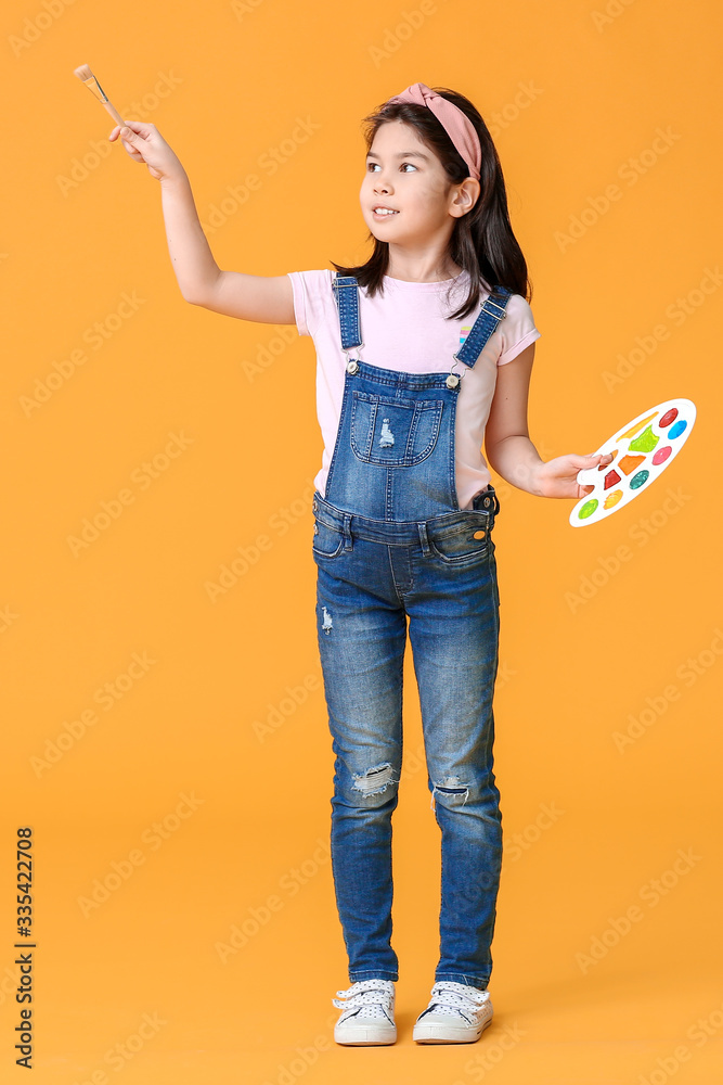 Cute little artist on color background