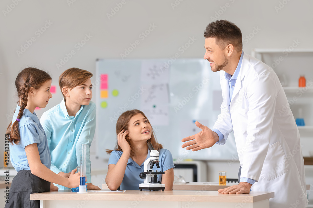 Teacher conducting chemistry lesson in classroom