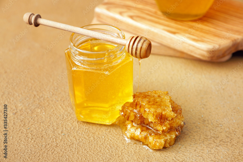 Jar of sweet honey on table