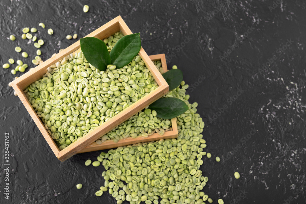 Green coffee beans on dark background