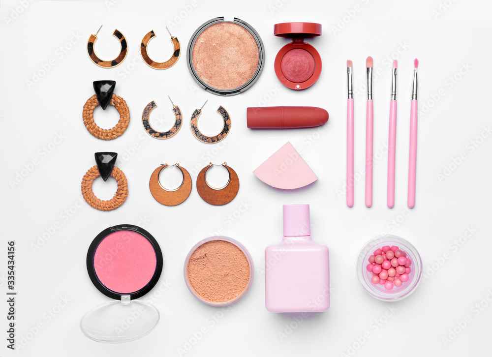 Makeup cosmetics with accessories on white background