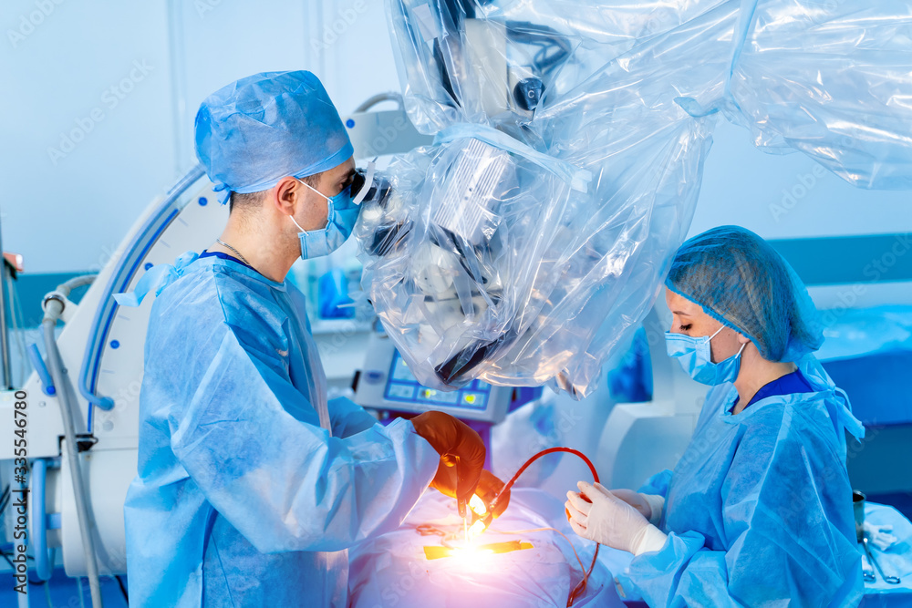 Team surgeon at work in operating room. Modern equipment in operating room. Medical devices for neur