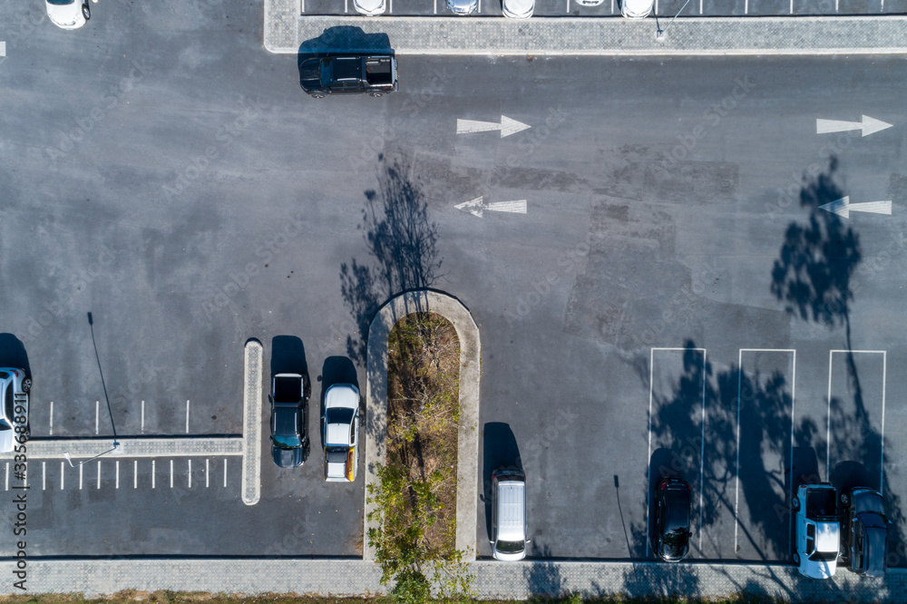 Aerial view drone shot of parking lot outdoors vehicles in the park