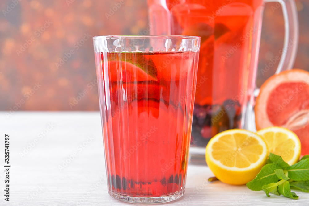 Glass of tasty cold tea on table