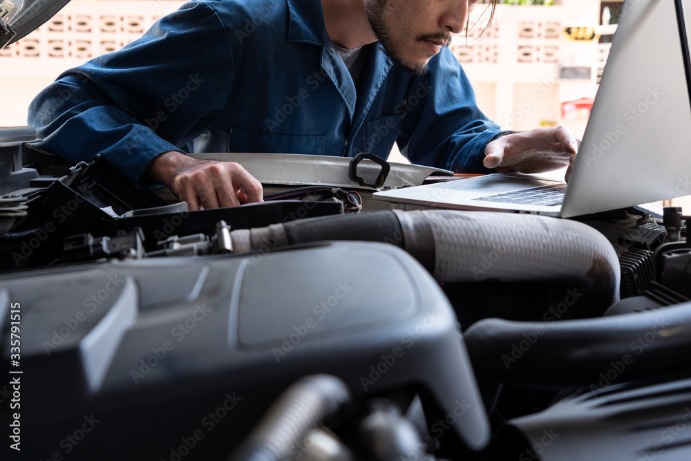 Professional mechanic providing car repair and maintenance service in auto garage. Car service busin