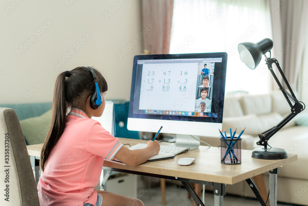 Asian girl student video conference e-learning with teacher and classmates on computer in living roo