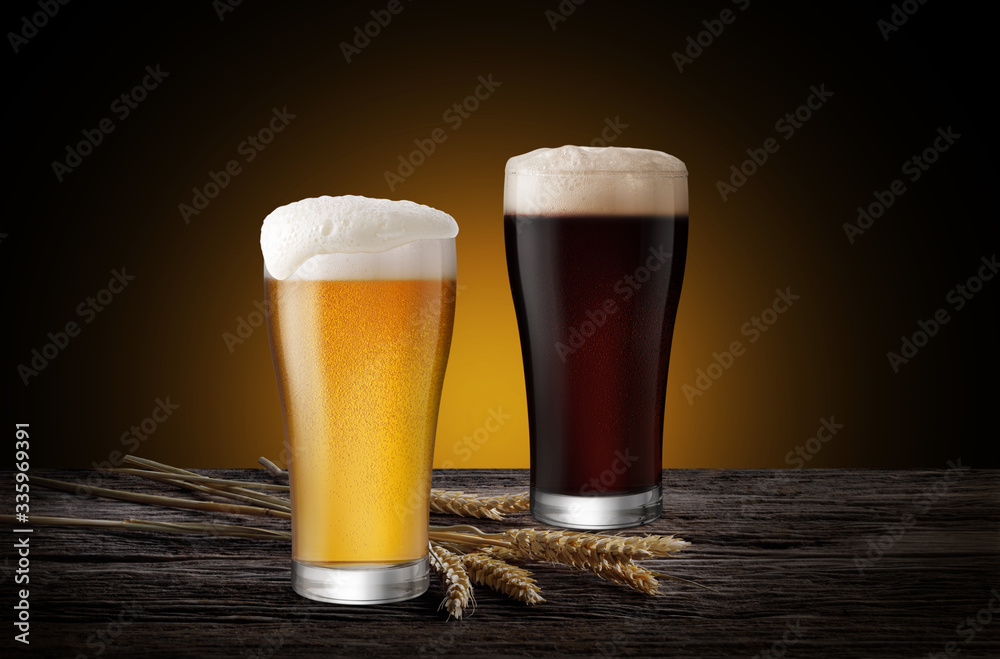 Glasses of Light Beer and Dark Beer with wheat on the bar counter in the restaurant at night, with c