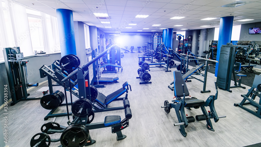 Empty fitness center hall. Modern and empty gym interior with equipment. Different sport equipment i