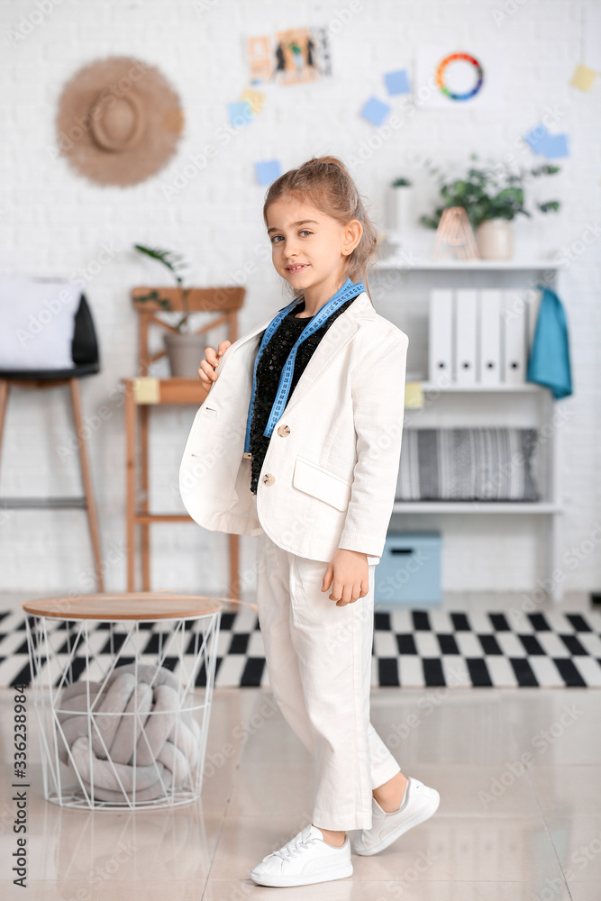 Cute little dressmaker in atelier