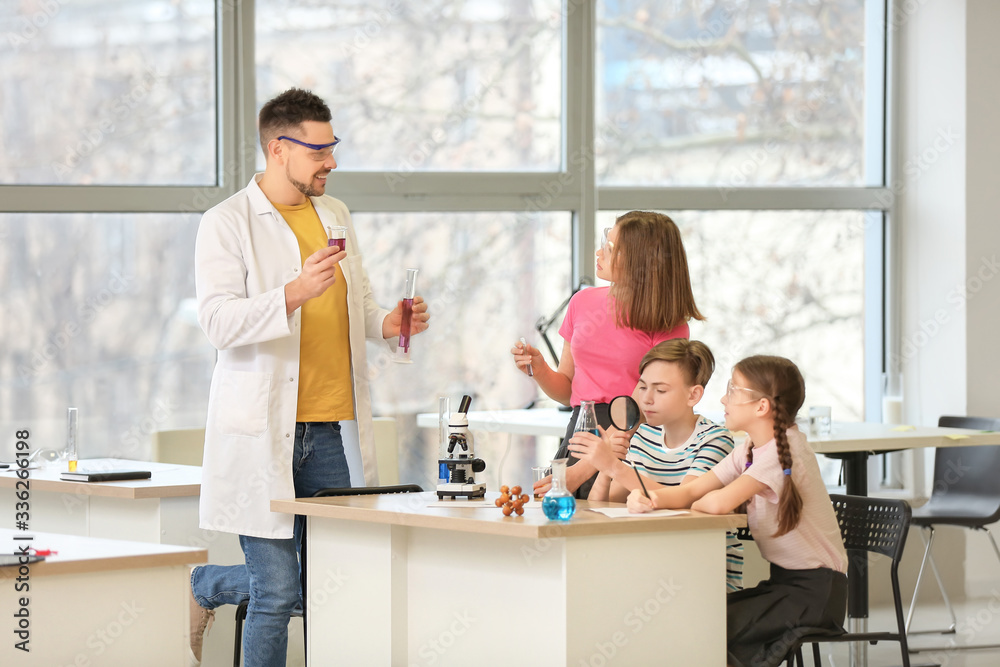 Teacher conducting chemistry lesson in classroom