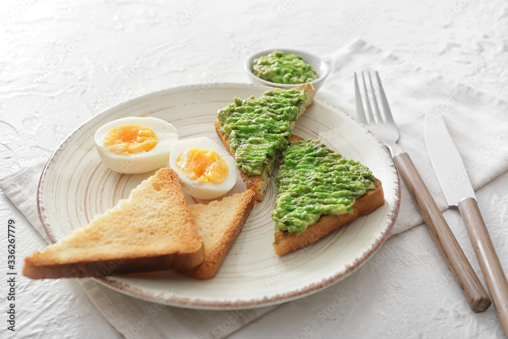 Plate with tasty avocado sandwiches on table