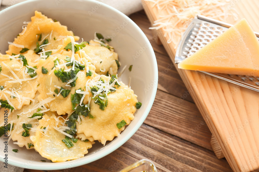 Plate with tasty ravioli on table