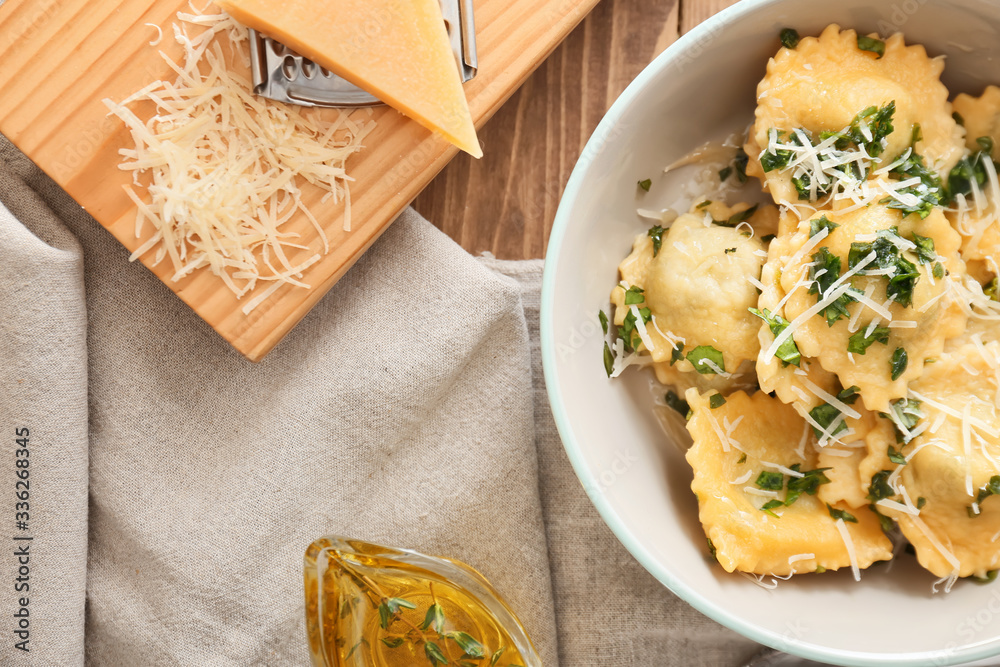 Plate with tasty ravioli on table