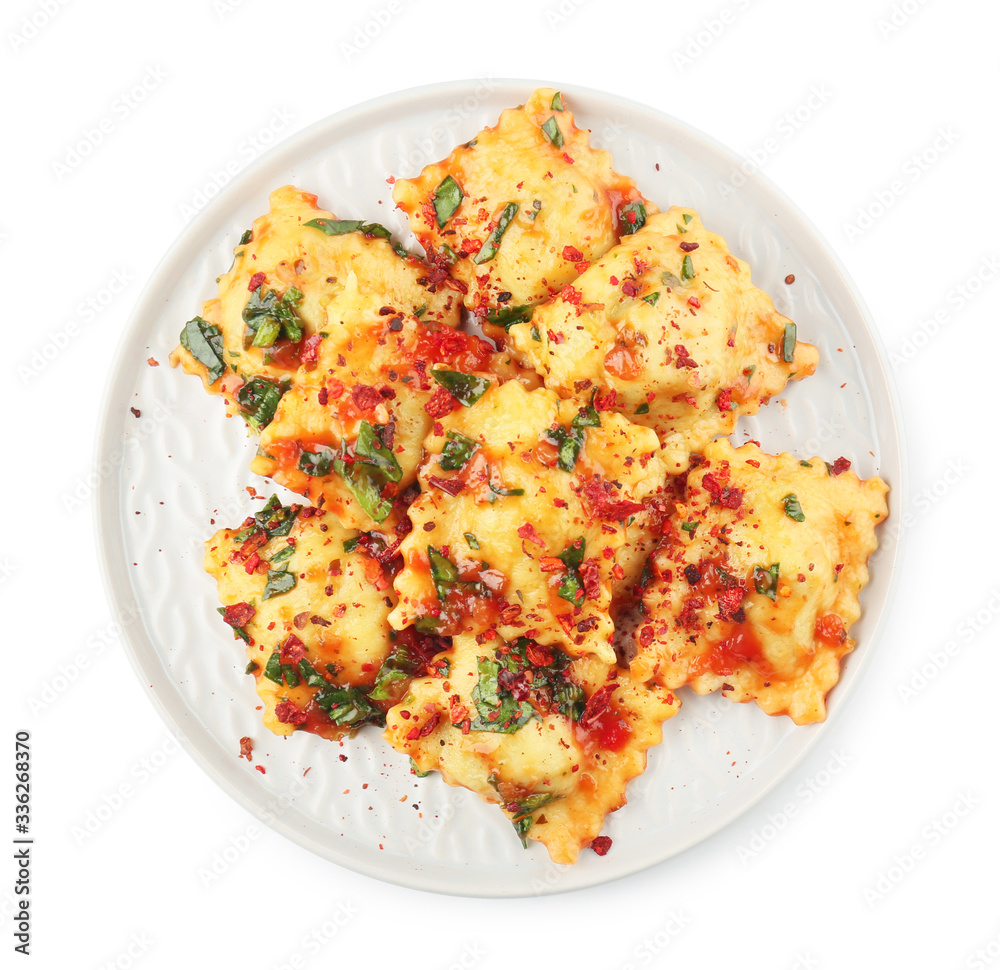 Plate with tasty ravioli on white background