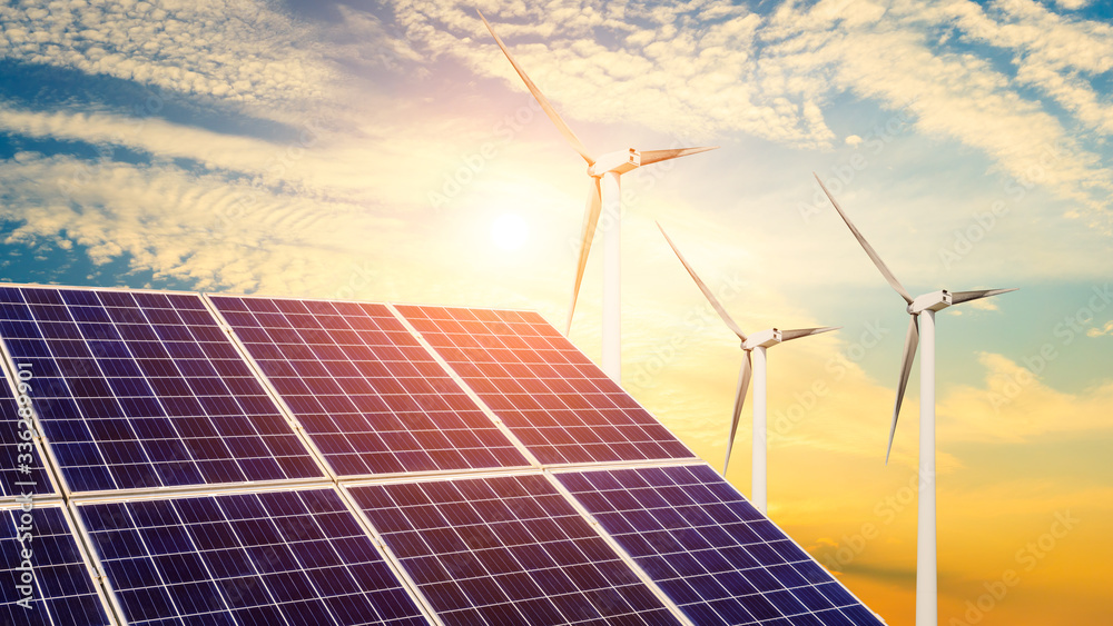 Solar panels with wind turbines in the setting sun,green energy.