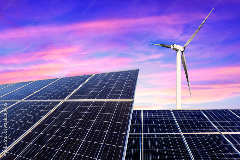 Solar panels with wind turbines in the setting sun,green energy.