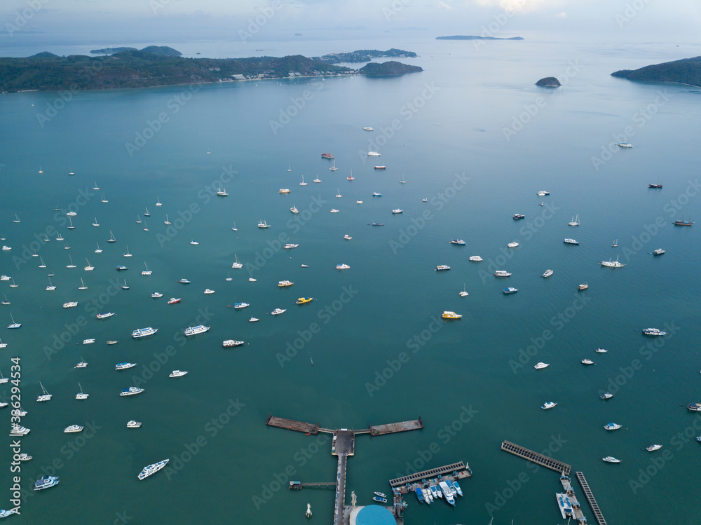 海湾鸟瞰图，游艇停泊，海湾被风景如画的山脉包围，多云的我们