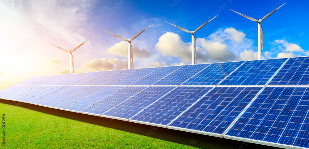 Solar panels with wind turbines in the setting sun,green energy.