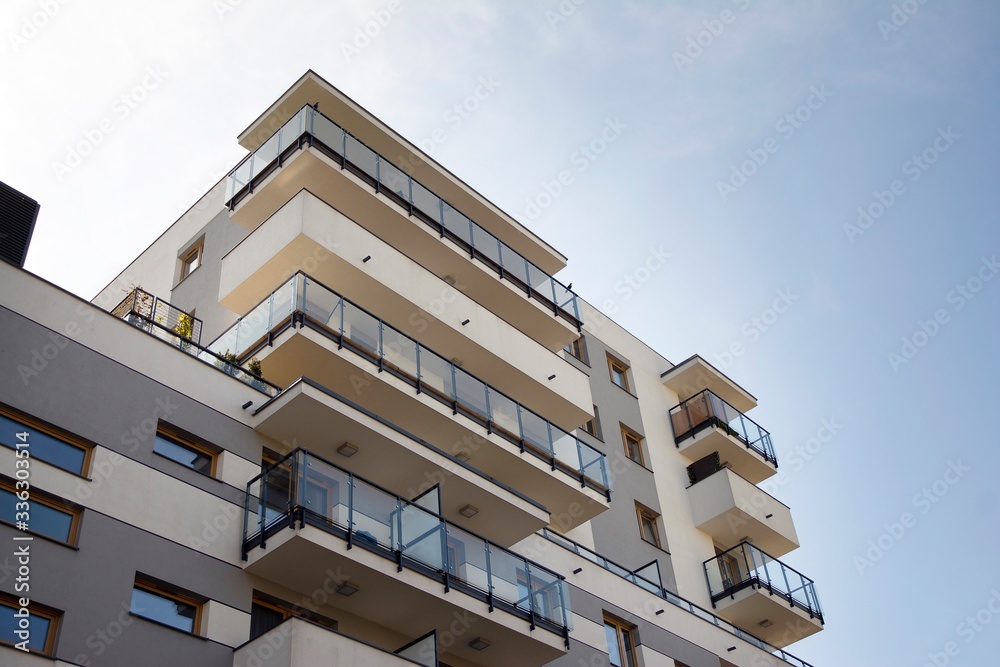 Exterior of new apartment buildings on a blue cloudy sky background. No people. Real estate business