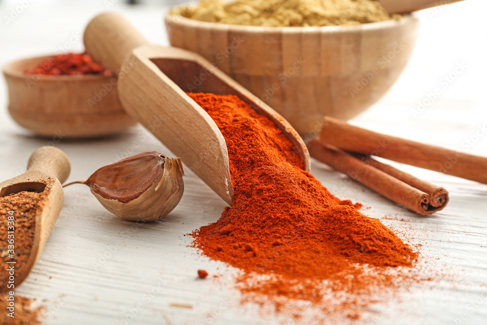 Different spices on white wooden background