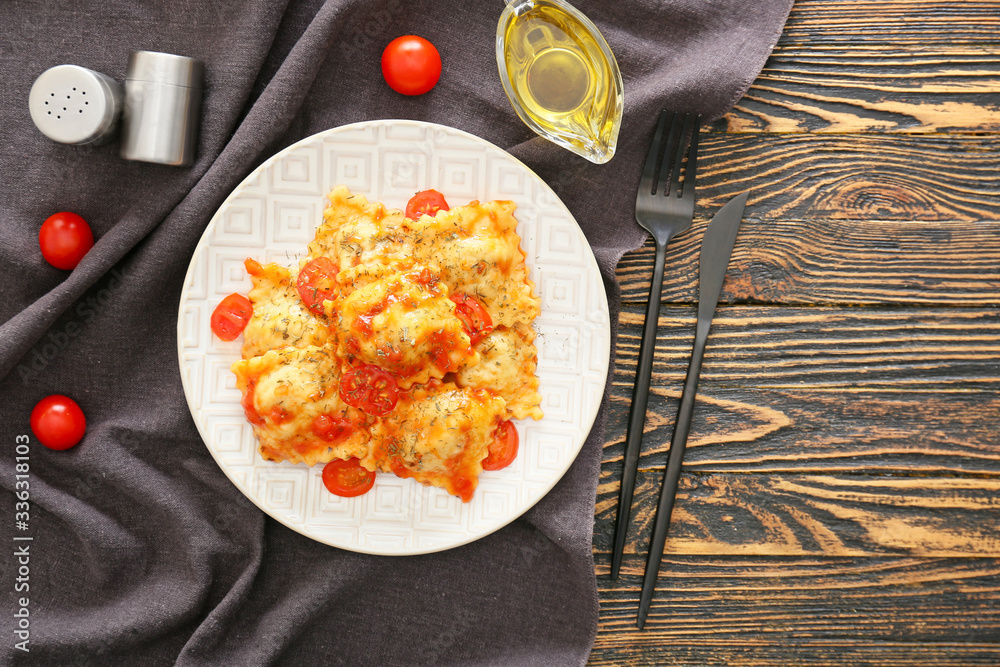 Plate with tasty ravioli on table