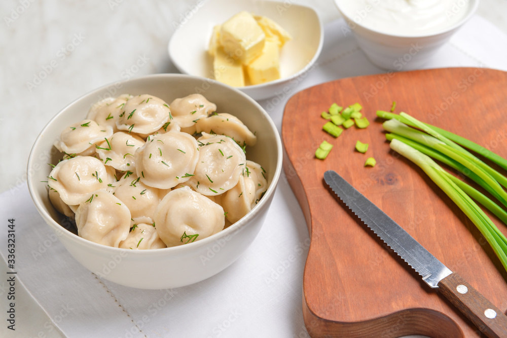 Bowl with tasty dumplings on table