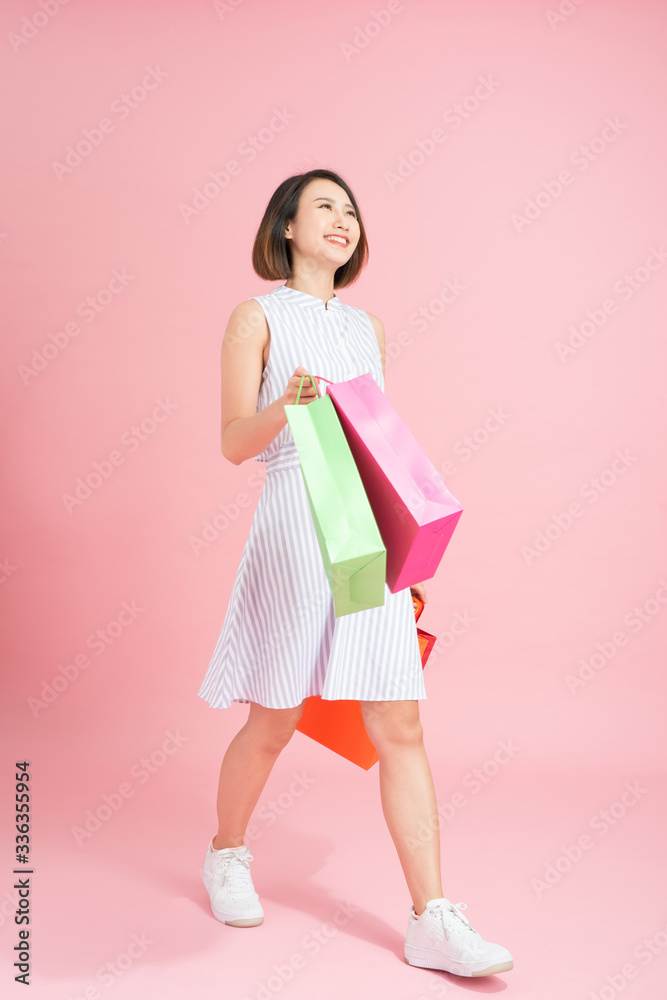 Excited female shopaholic with shopping bags